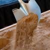 Close up photo of shovel and sand at a groundbreaking ceremony
