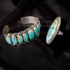 Kingman turquoise and silver bracelet and ring on back fabric