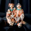 Product shot of Native American storyteller figure sculpture on black velvet