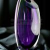 Product shot of purple glass vase on black satin